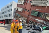 Firefighters work at the site where a building collapsed following the earthquake, in Hualien, Taiwan
