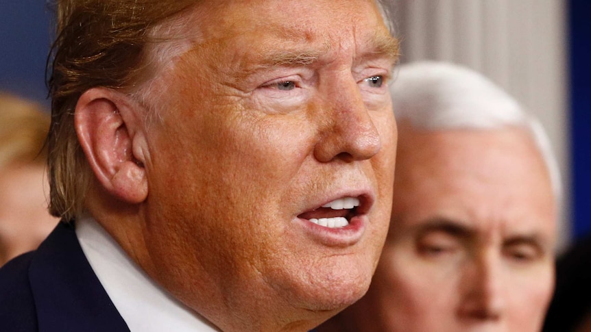 President Donald Trump speaks as Vice President Mike Pence listens