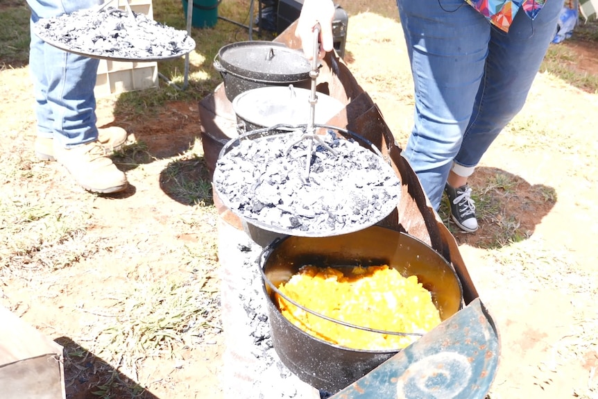 Old cast-iron camp oven with pumpkin soup