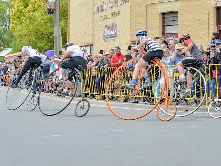 competitors in a penny farthing race