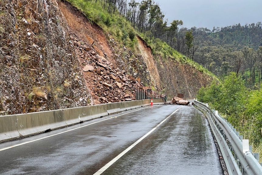 A large boulder blocking the road. 