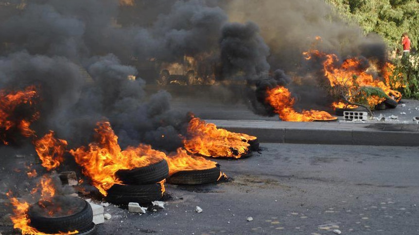 Burning tyres to block a road in the Jobar neighbourhood of Damascus.