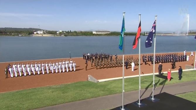 Flags are unfurled as service people form on the banks of Lake Burley Griffin in Canberra on Australia Day 2019.