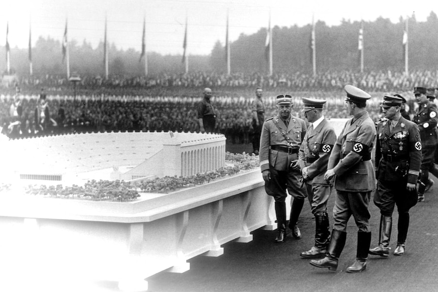 Adolf Hitler and architect Albert Speer inspect model for a huge stadium to be built at Nuremberg.
