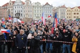 Demonstrators wave Czech flags and shout, many not wearing masks, at a protest against coronavirus measures in Prague.