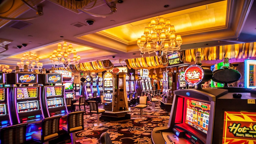 A casino gaming floor showing poker machines and bright lighting