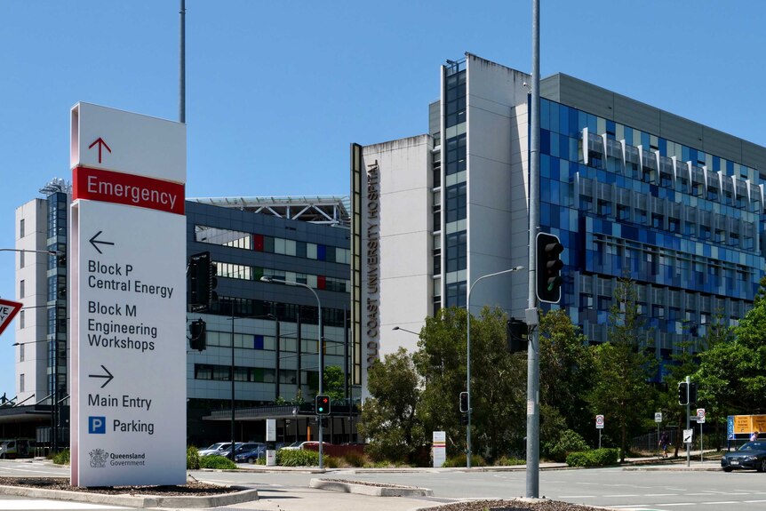 Exterior photo of the Gold Coast university hospital with an emergency sign in the foreground