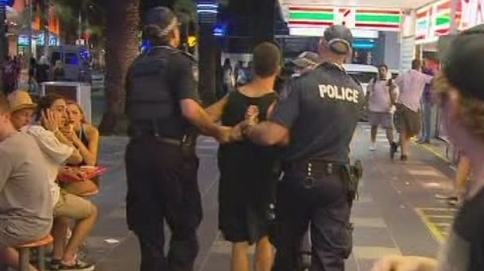 Man taken away by police at Schoolies