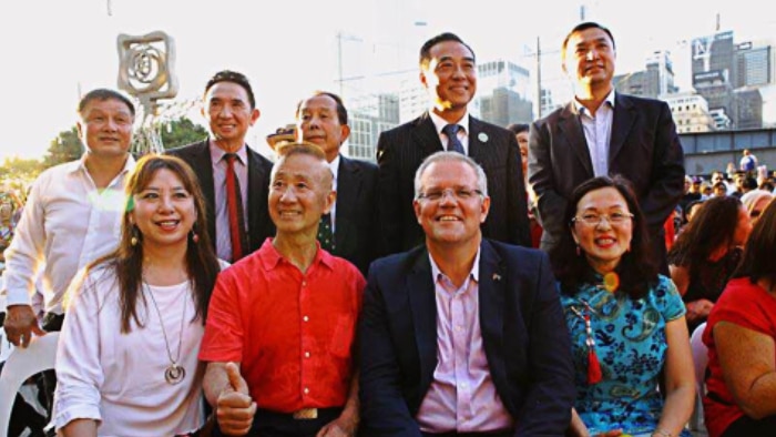 Scott Morrison and Gladys Liu pose for a photo with a group of people at Lunar New Year celebrations
