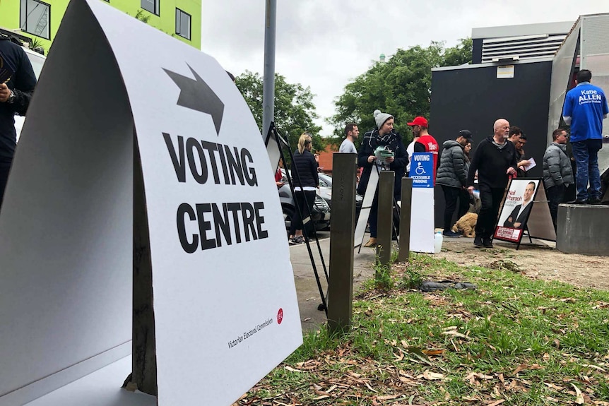 A voting centre sign pointing to a polling booth.