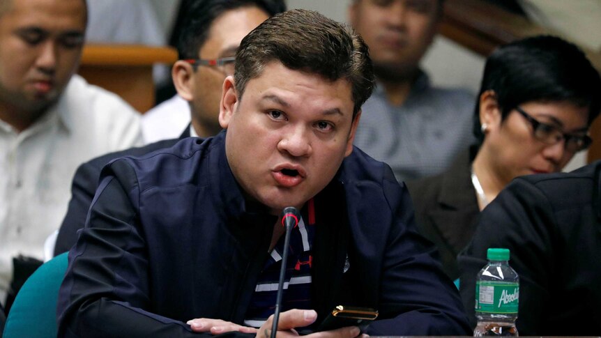 Paolo Duterte testifies at a Senate hearing wearing a blue jacket.