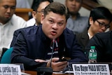 Paolo Duterte testifies at a Senate hearing wearing a blue jacket.