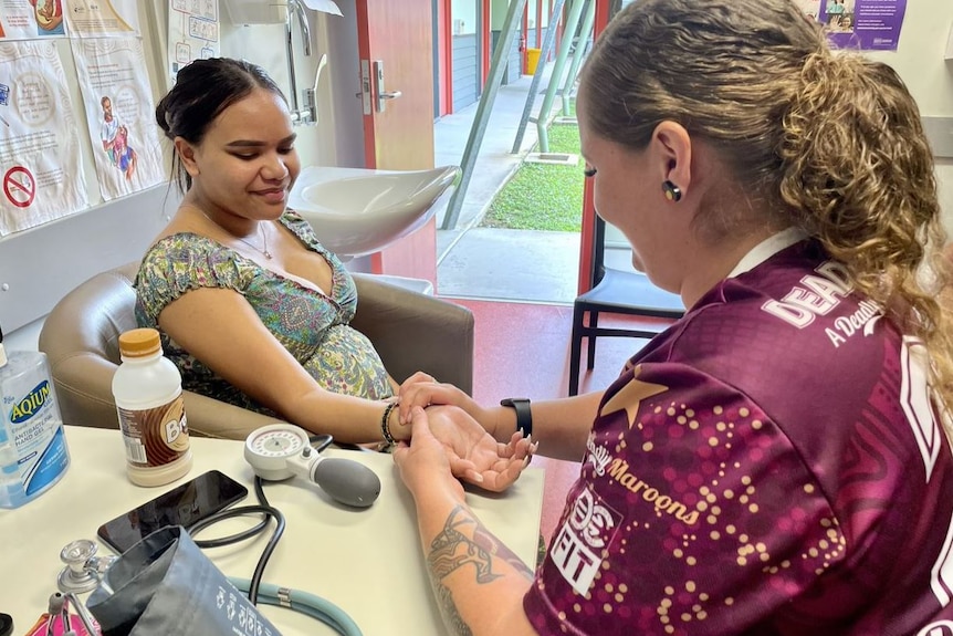 Yarrabah’s midwife Tayla Smith checks the blood pressure of a patient in her office