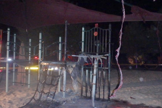 Playground equipment that has been badly damaged by fire.
