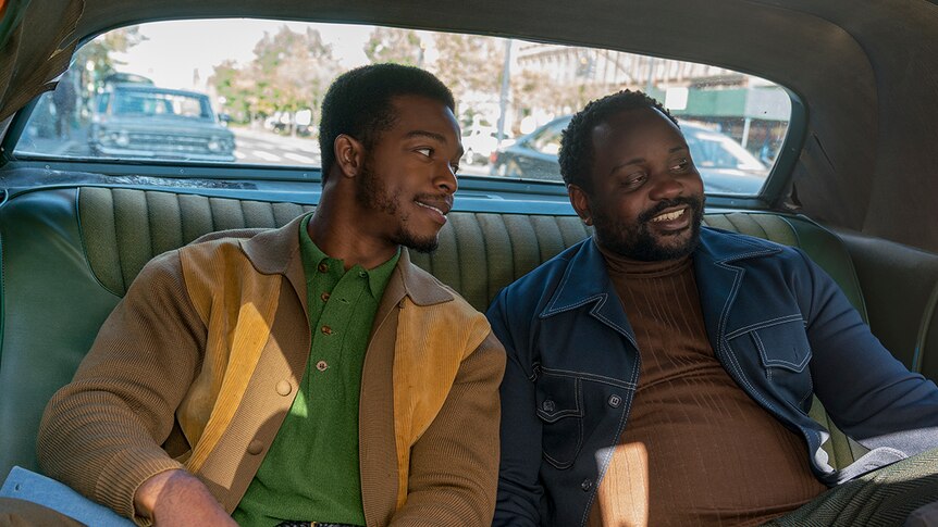 Colour still of Stephan James and Brian Tyree Henry sitting in backseat of car in 2018 film If Beale Street Could Talk.