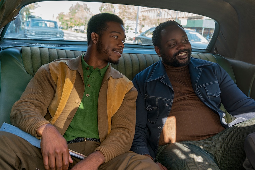 Colour still of Stephan James and Brian Tyree Henry sitting in backseat of car in 2018 film If Beale Street Could Talk.