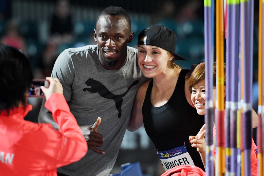 Usain Bolt poses with Hiroko Takigawa and Kara Winger