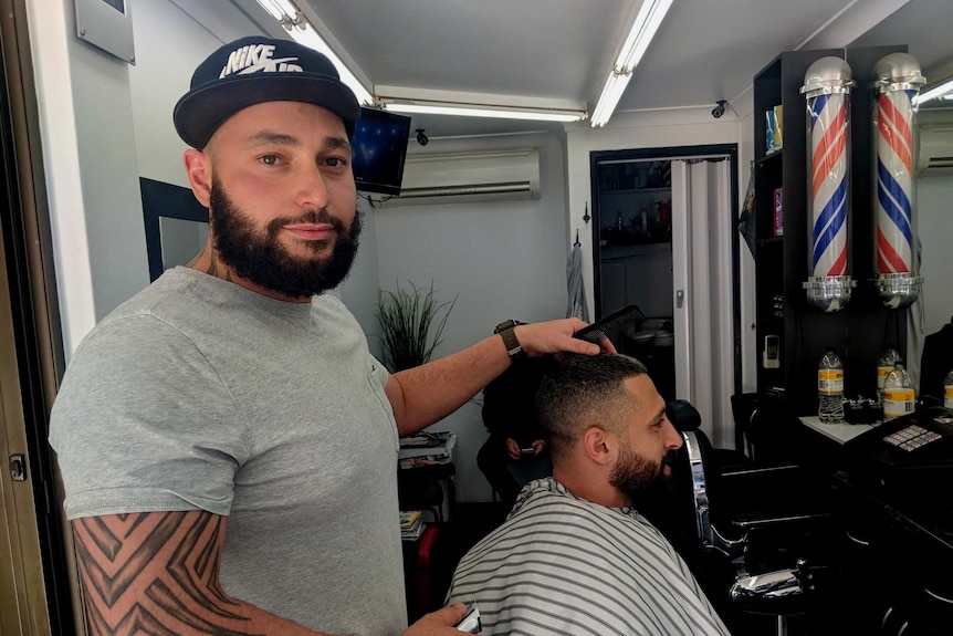 Two men at a barber shop