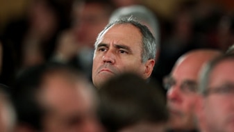 Ken Henry watches Wayne Swan speak during his post-budget address, May 12, 2010 (Getty Images: Mark Nolan)