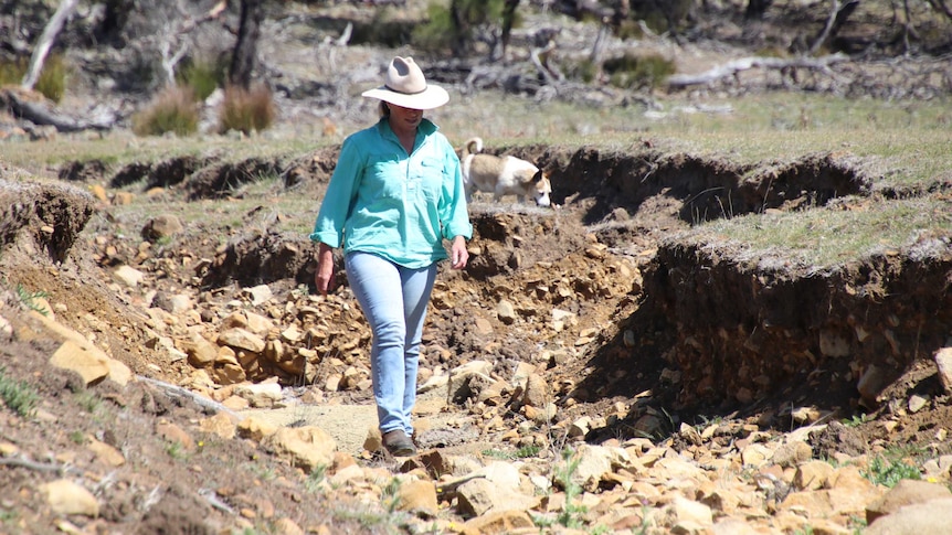 Steph Brouder walks a dry creek bed at her property near Cranbrook, Tasmania, in October, 2018.