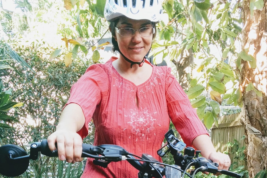 A woman on a bike.