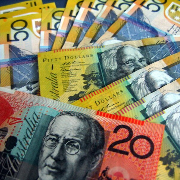 Australian banknotes, mostly $50 bills, strewn over a flat surface.