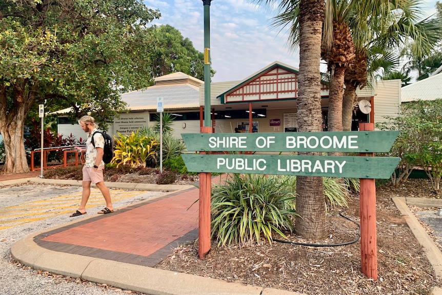 A large building surrounded by trees with large sign saying Broome Public Library
