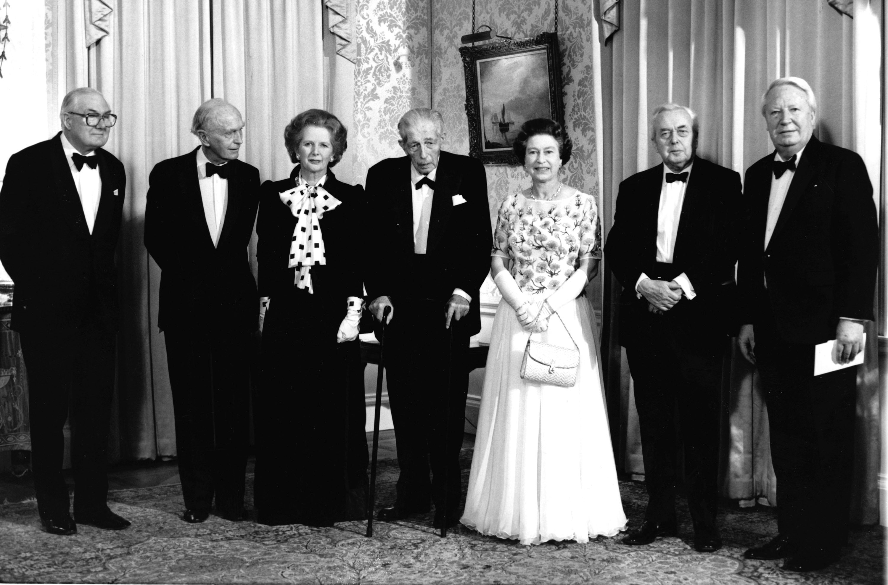 Queen Elizabeth II stands in the centre of UK Prime Ministers past and present.