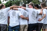 A group of men with their arms around each other