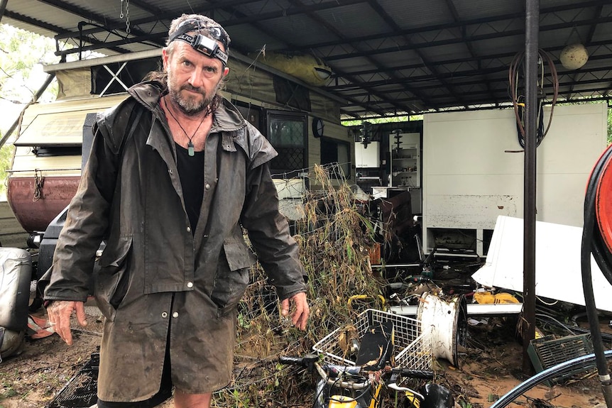 Resident Steve Sinclair stands among his flood-damaged property at Bluewater, near Townsville in north Queensland.