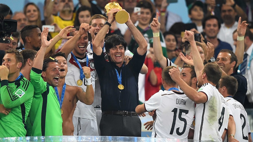 Joachim Loew celebrates with World Cup trophy