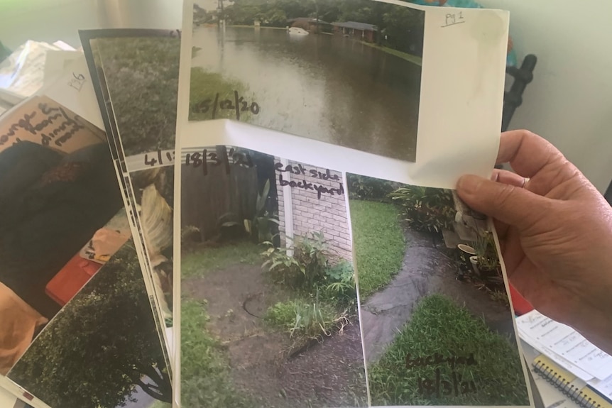 A close-up of photos of flooded property with notes about them.