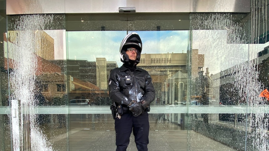 A police officer covered in paint 