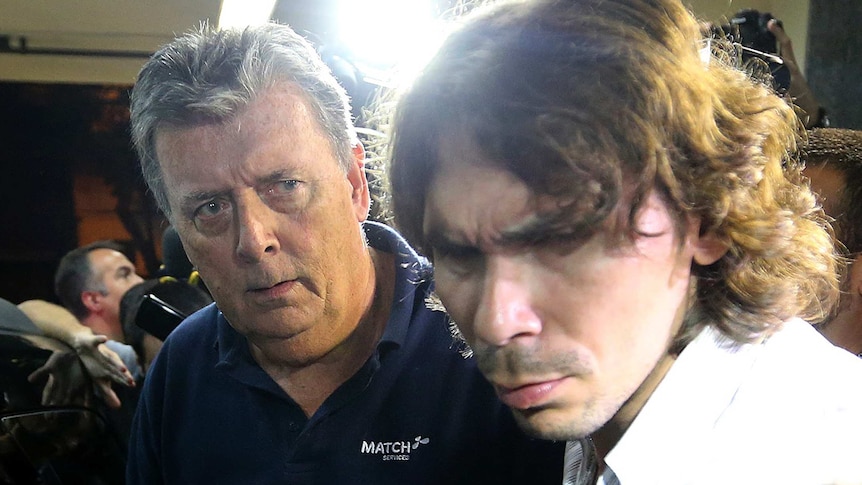 Ray Whelan (L), of Match Services, at a police station after being arrested on July 7, 2014.