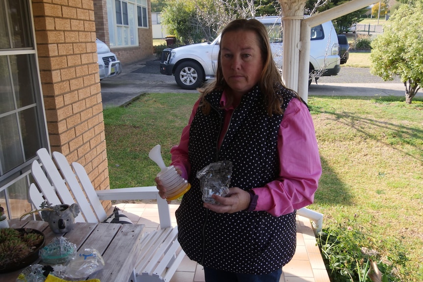 A woman holding a pump device. 