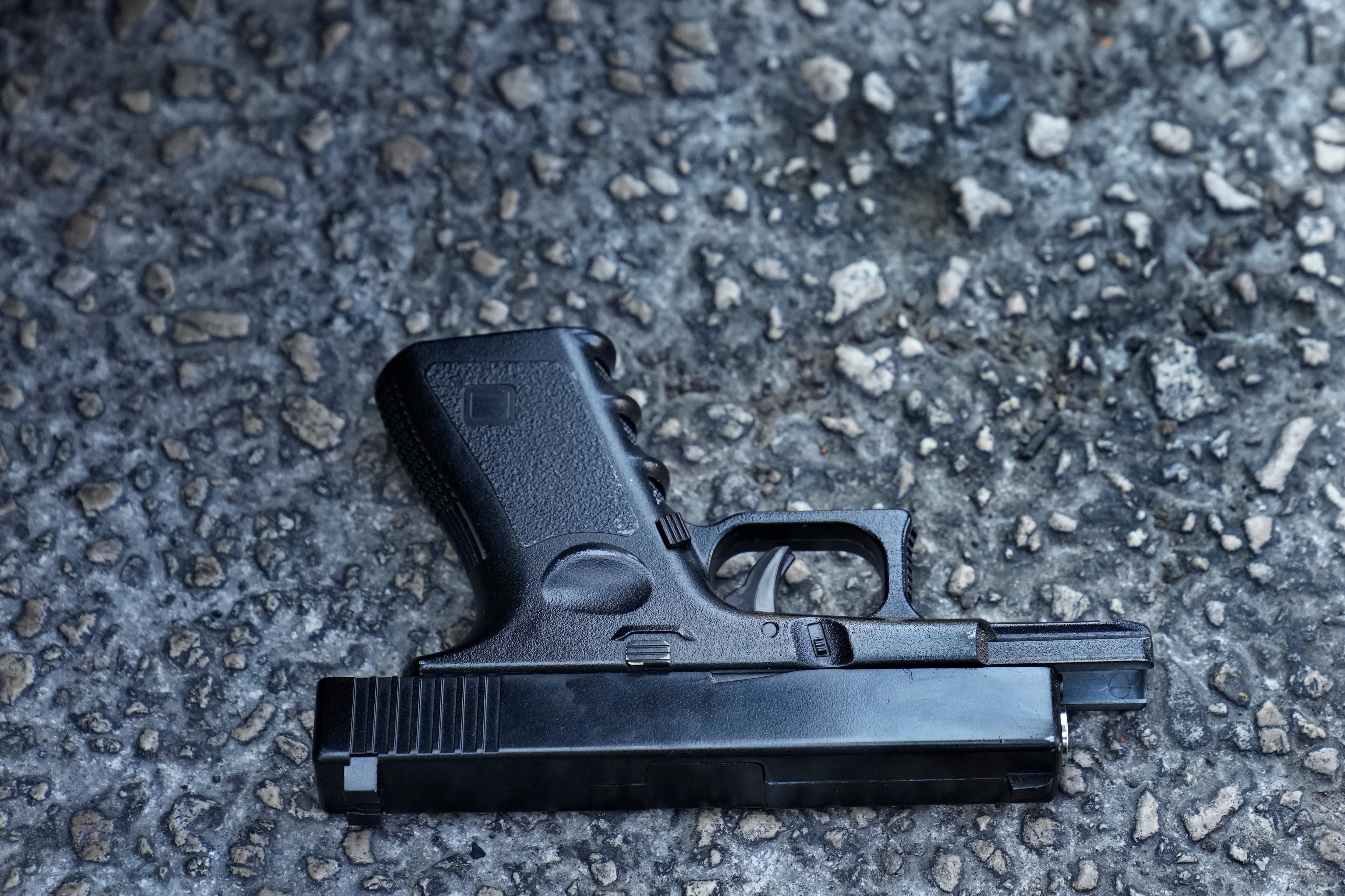 A toy pistol that was used by depositors to attack a bank is seen thrown on the ground.