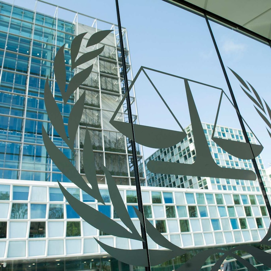 A symbol of the scales of justice on a glass window at the ICC