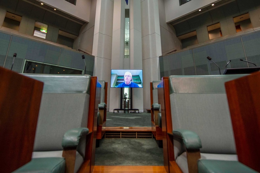 Nationals MP Damian Drum's face on a TV monitor in the parliamentary chamber at Parliament House in Canberra.