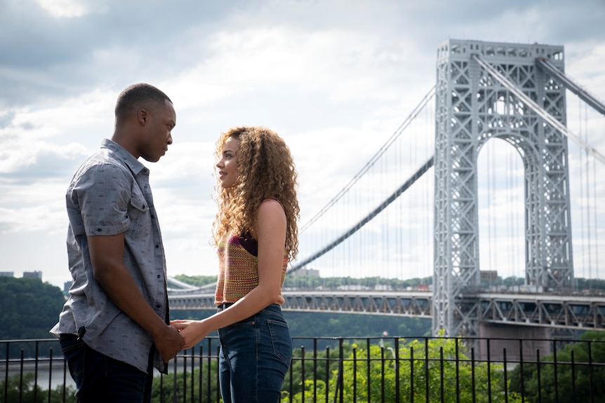 Anthony Ramos and Melissa Barrera, a young Latinx couple dancing in the street, In The Heights 