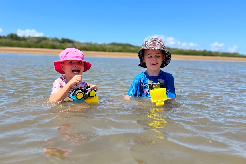 A boy and girl  playing in a dam