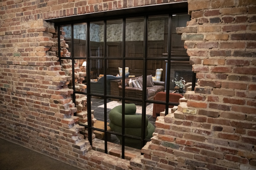 A brick wall with a glass window.