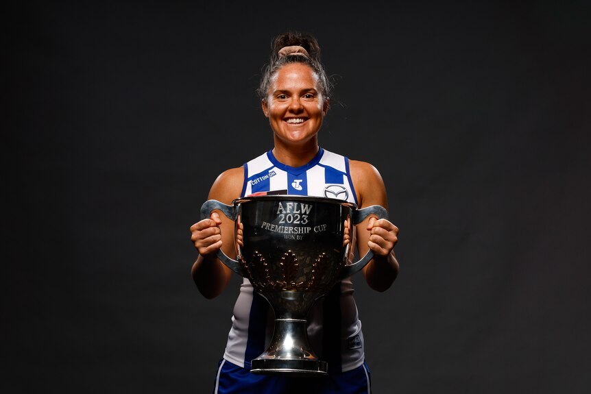 Emma Kearney of the Kangaroos poses with the AFLW Premiership trophy