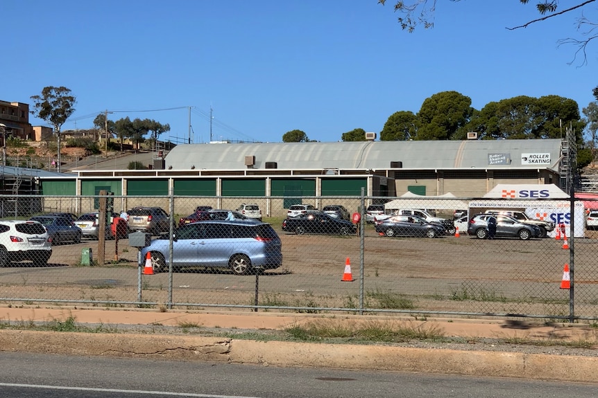 Broken Hill memorial oval pop-up testing site with a line of cars snaking around the dusty car park