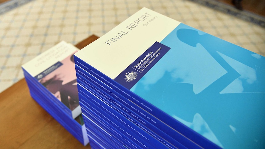 The volumes of the Child Abuse Sexual Abuse report stacked on a table.