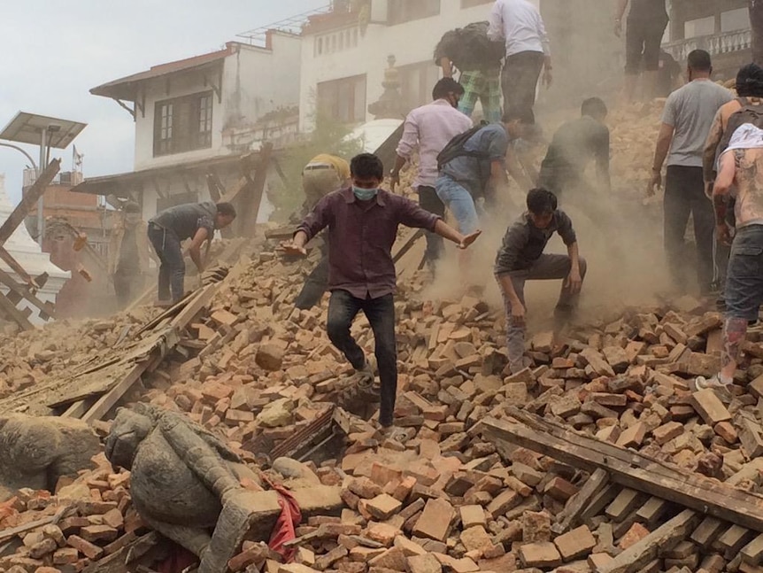 Survivors try to clear rubble after Kathmandu earthquake