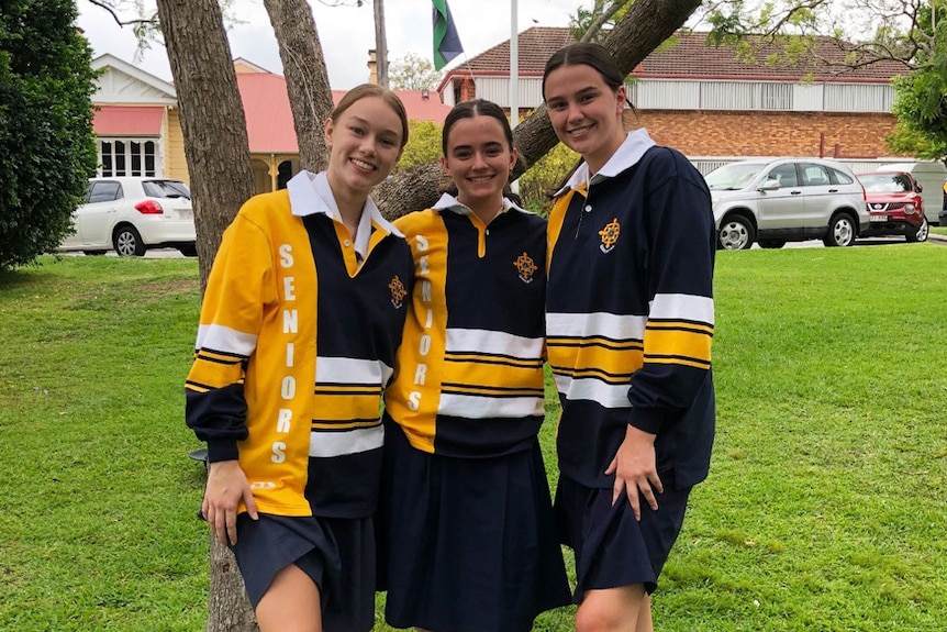 Year 12 student Abby Hewett (middle) and two friends at Mt St Michael's College in Brisbane.