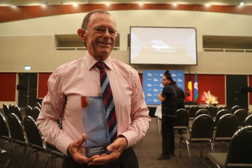 Dr Geoffrey Thompson holds his award for NT Australian of the Year
