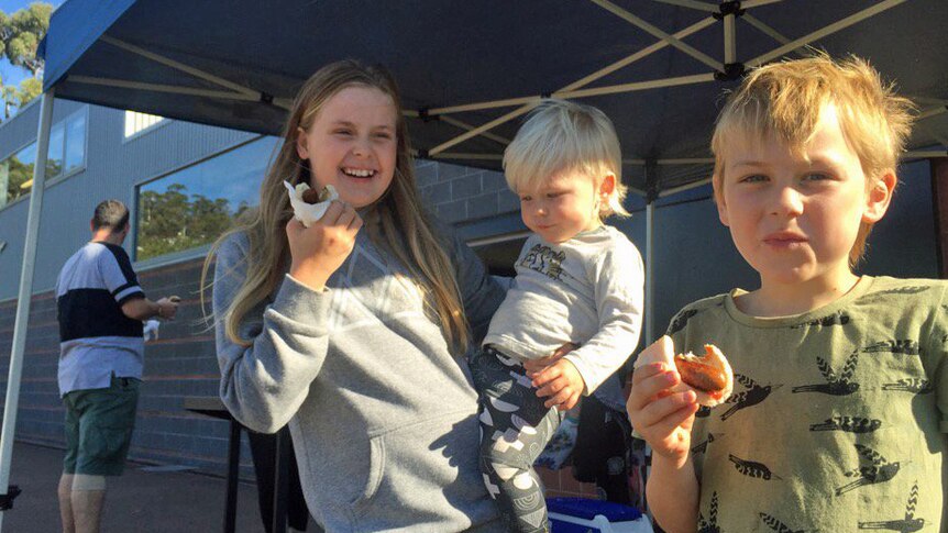 Kids eat sausages at a Tasmanian polling booth