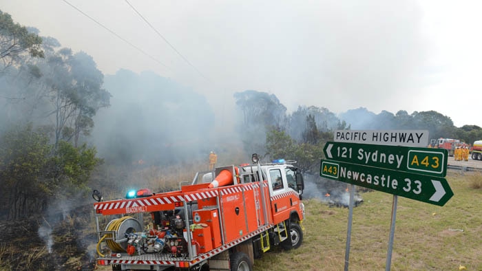 Rural Fire Service volunteers conducting back-burning in the Catherine Hill Bay area.