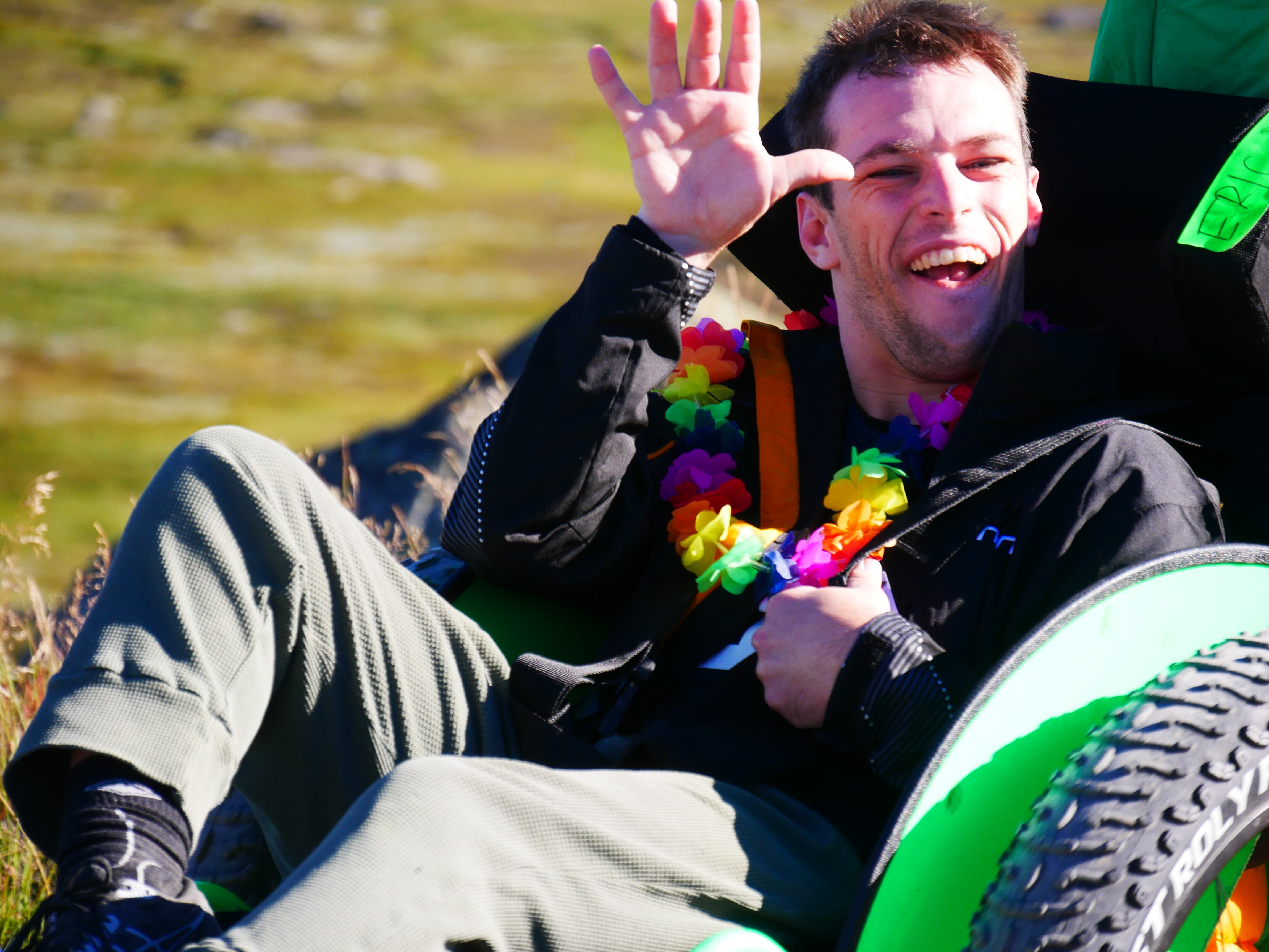 a man smiles happily from a wheelchair